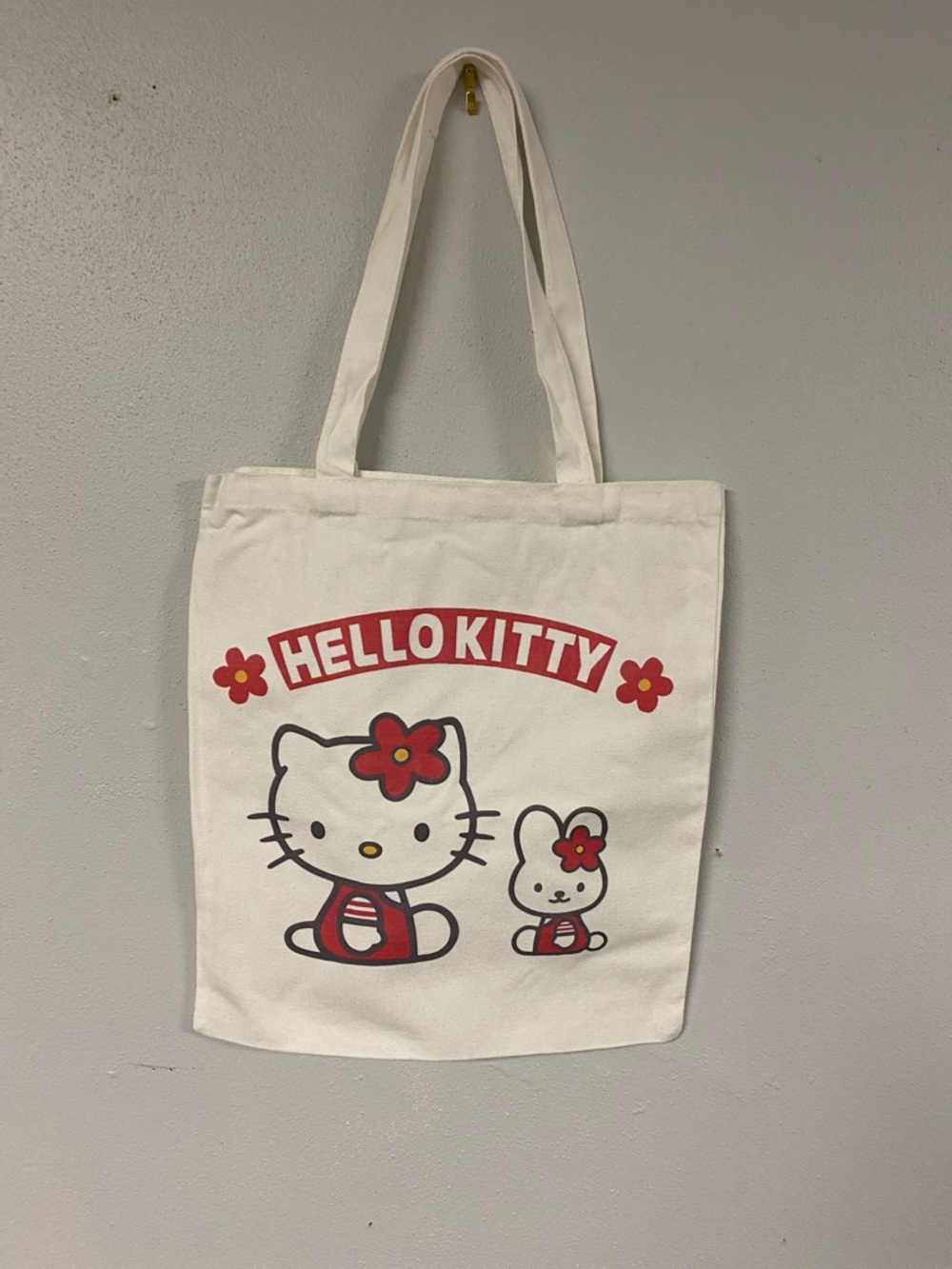 Hello Kitty White Canvas Tote with Red Floral Graphic.